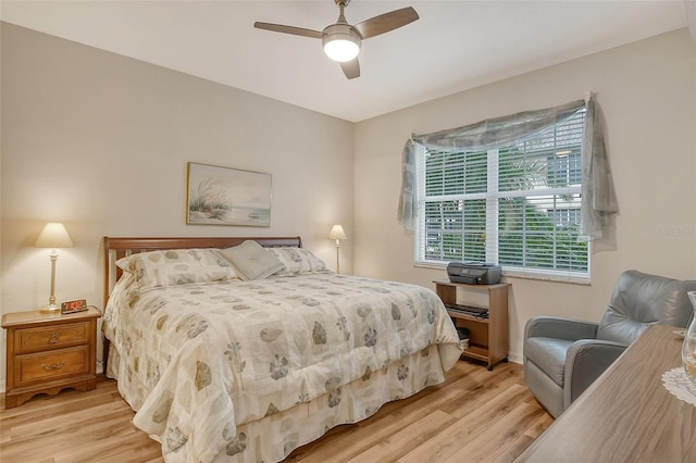 bedroom with light hardwood / wood-style floors and ceiling fan