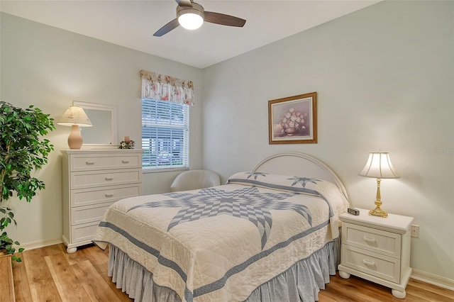 bedroom with ceiling fan and light hardwood / wood-style flooring