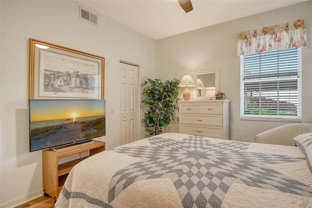 bedroom with ceiling fan, a closet, and light hardwood / wood-style flooring