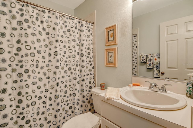 bathroom with toilet and vanity