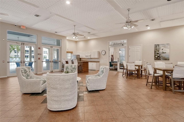 living room featuring light tile patterned floors, ceiling fan, and french doors