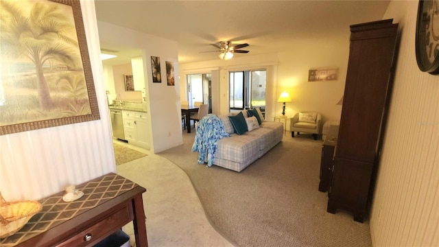 living room with ceiling fan and light colored carpet