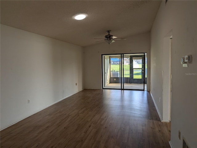 empty room featuring ceiling fan, dark wood-type flooring, and a textured ceiling