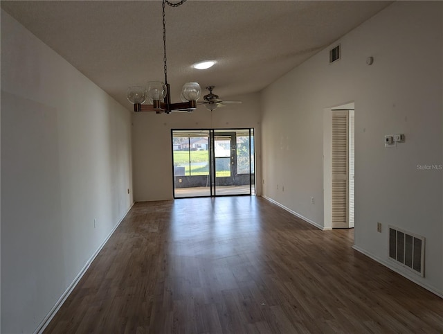 unfurnished room featuring ceiling fan with notable chandelier, dark wood-type flooring, and a textured ceiling