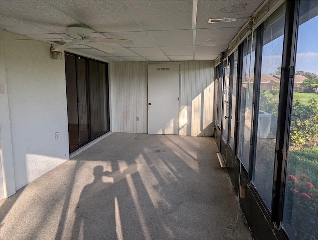 unfurnished sunroom with a drop ceiling