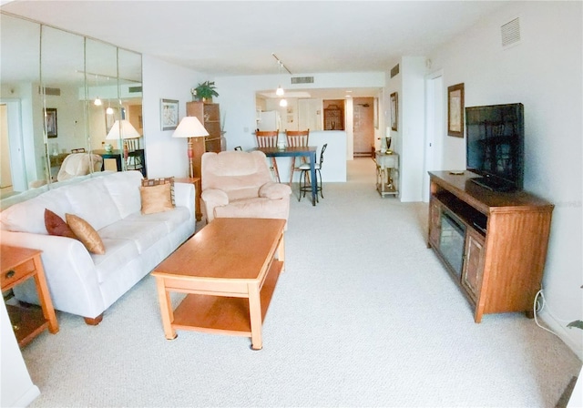 living room with visible vents and light colored carpet