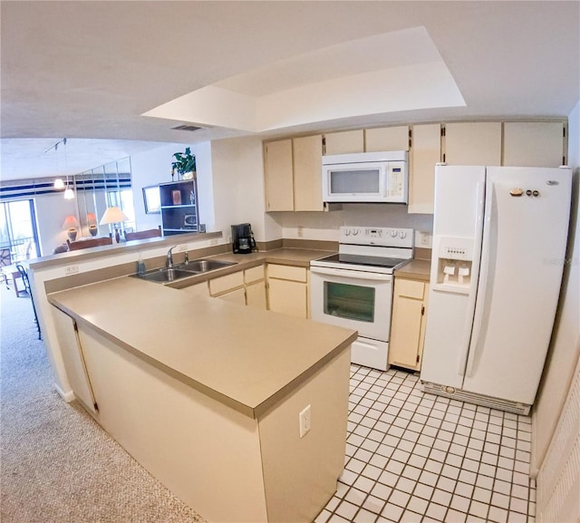 kitchen with white appliances, visible vents, a peninsula, cream cabinetry, and a sink