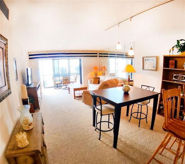 dining space featuring carpet floors, visible vents, and track lighting