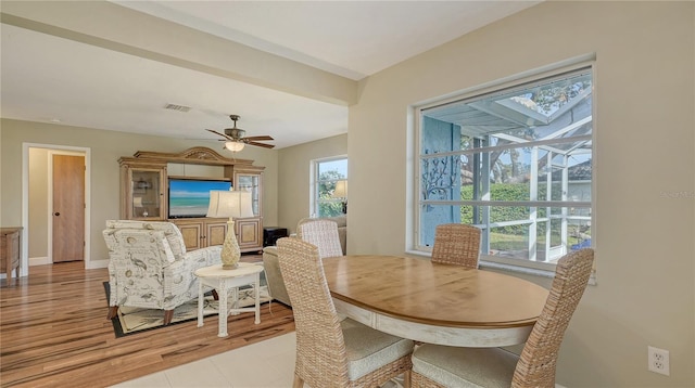 dining space with ceiling fan and light hardwood / wood-style floors