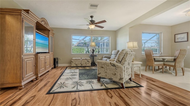 sitting room with light hardwood / wood-style floors and ceiling fan