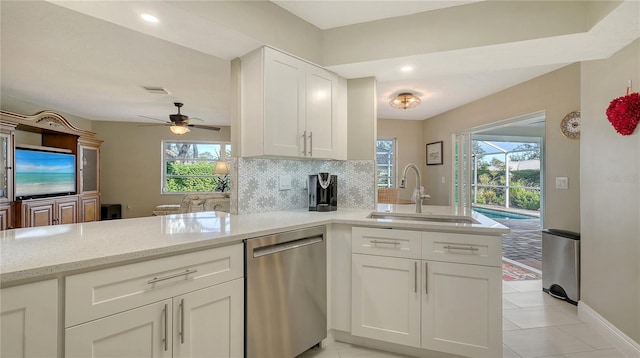 kitchen with white cabinetry, dishwasher, sink, and kitchen peninsula