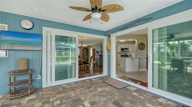 doorway to property featuring ceiling fan and a patio area