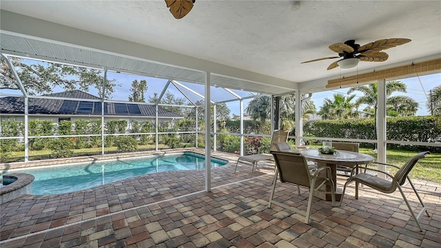 view of swimming pool with ceiling fan and a patio area