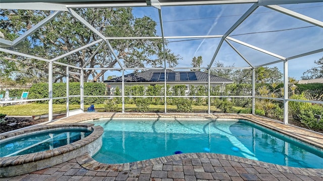 view of pool featuring an in ground hot tub and glass enclosure