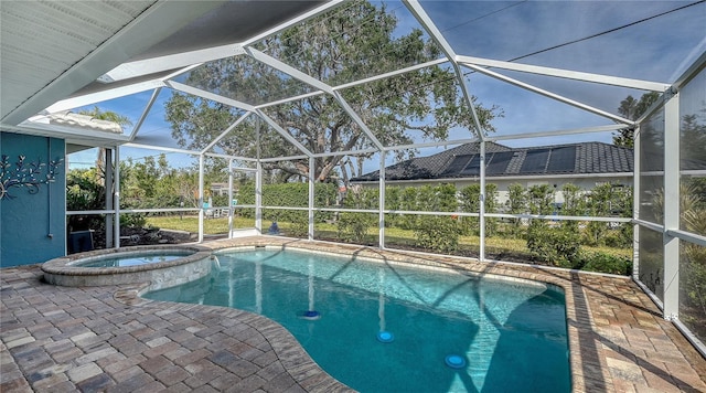 view of swimming pool with a lanai, a patio area, and an in ground hot tub