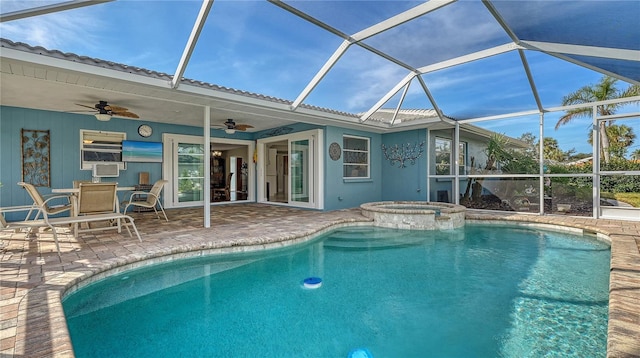 view of pool with glass enclosure, a patio, ceiling fan, and an in ground hot tub