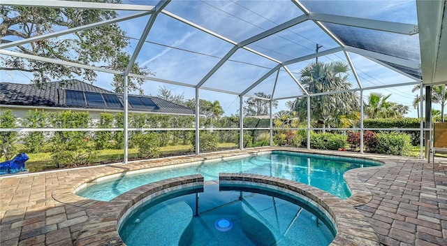 view of swimming pool featuring an in ground hot tub, a patio, and glass enclosure