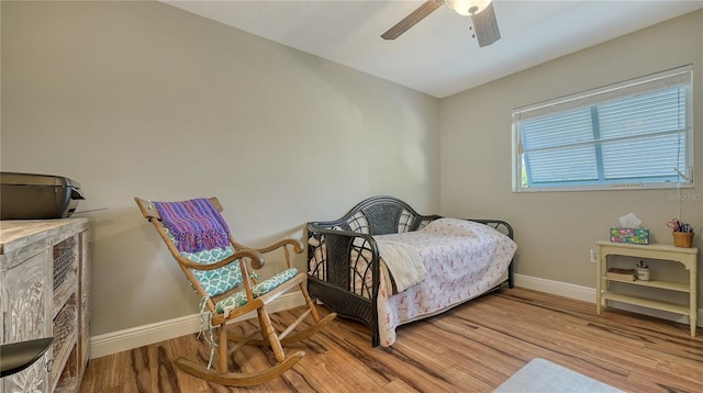 bedroom with ceiling fan and light hardwood / wood-style floors