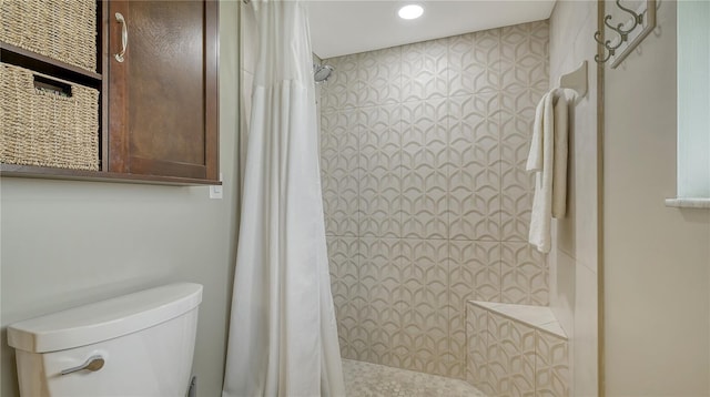 bathroom with a shower with curtain and toilet