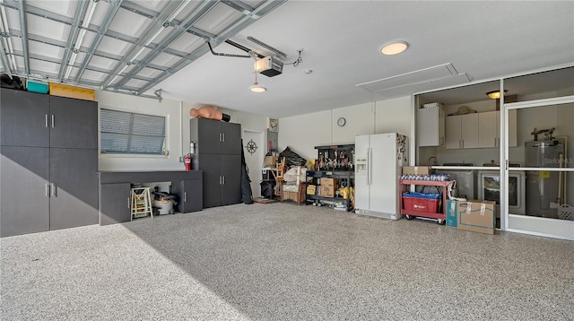 garage with a garage door opener, washer / clothes dryer, water heater, and white fridge with ice dispenser