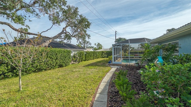 view of yard with a fenced in pool and a lanai