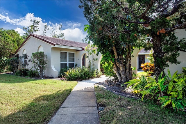 mediterranean / spanish-style house featuring a front yard