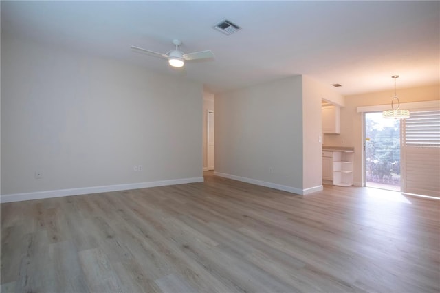 unfurnished living room with light wood-type flooring and ceiling fan