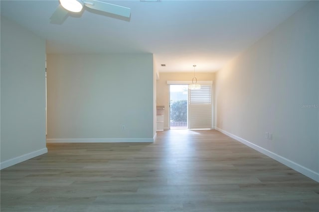 spare room featuring light wood-type flooring and ceiling fan