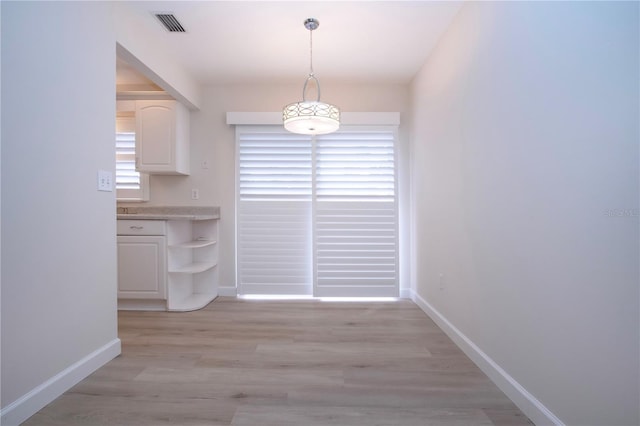 unfurnished dining area featuring light hardwood / wood-style floors