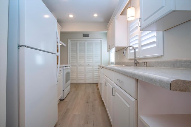 kitchen featuring sink, white appliances, white cabinets, and light hardwood / wood-style floors