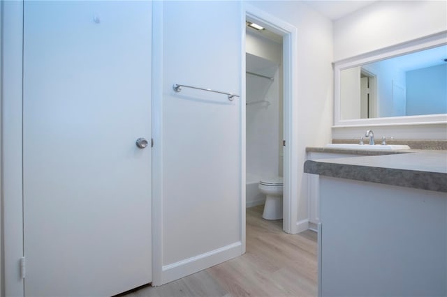 bathroom with wood-type flooring, toilet, and vanity