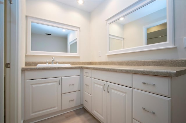 bathroom featuring hardwood / wood-style floors and vanity