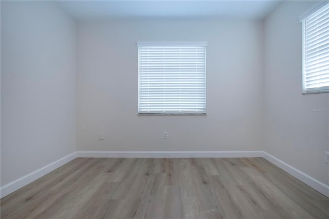 unfurnished room with light wood-type flooring