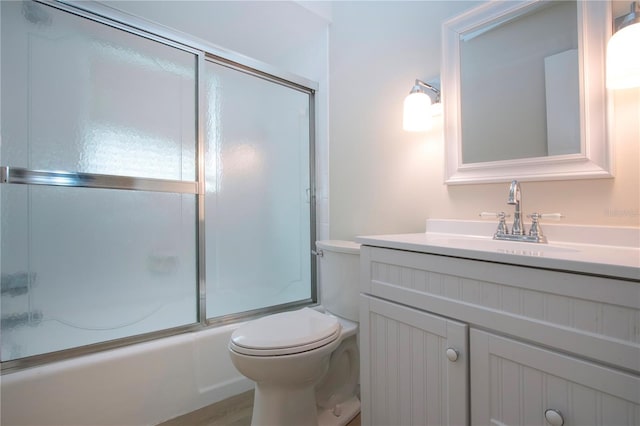 full bathroom with vanity, toilet, combined bath / shower with glass door, and wood-type flooring