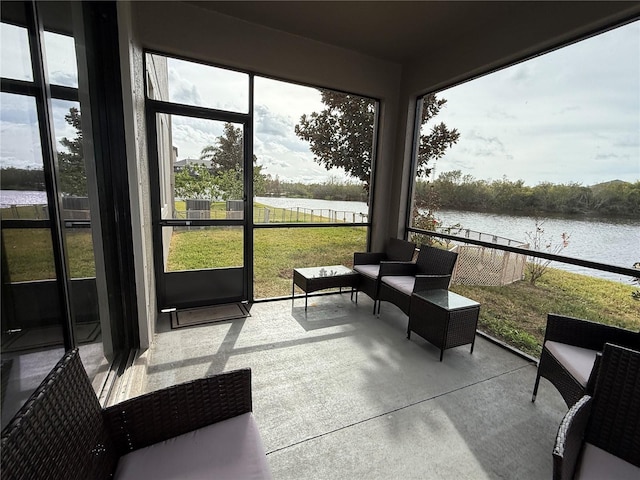 sunroom / solarium with a water view and a healthy amount of sunlight