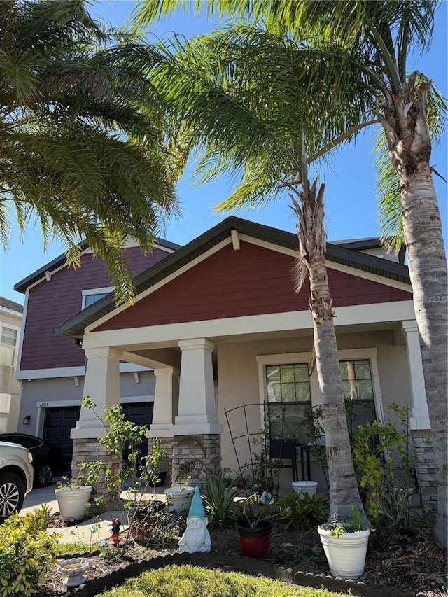 view of front of property featuring a garage and a porch