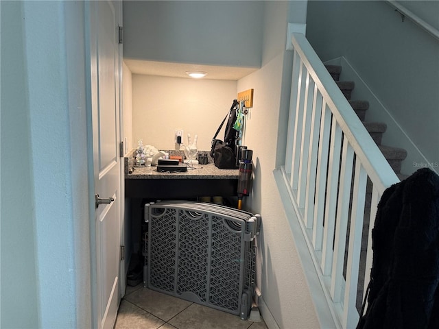 staircase featuring tile patterned flooring