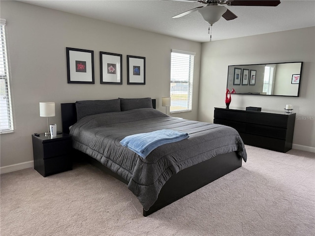 bedroom featuring ceiling fan and light colored carpet