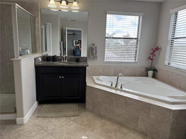 bathroom with independent shower and bath, vanity, and tile patterned flooring