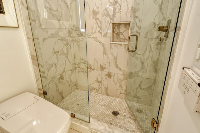 bathroom with a shower with door