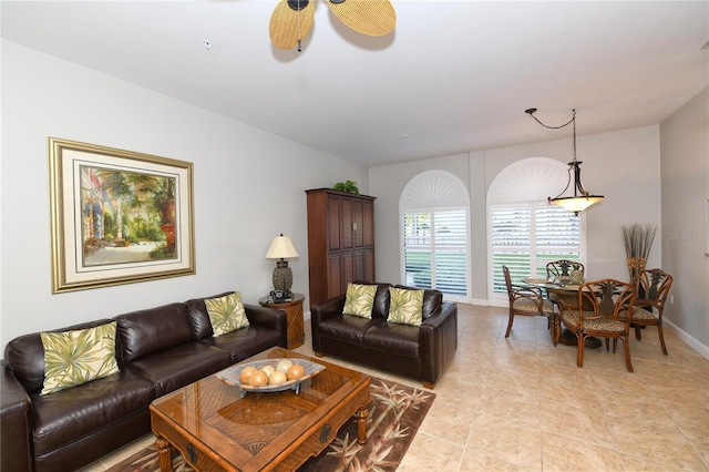 tiled living room featuring ceiling fan