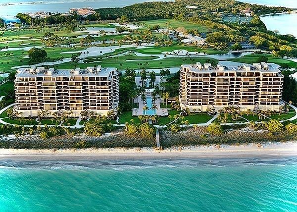 birds eye view of property with a water view and a view of the beach