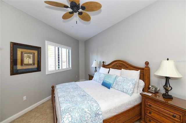 bedroom with light tile patterned floors, vaulted ceiling, and ceiling fan