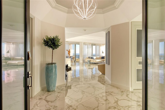 corridor featuring crown molding and a notable chandelier