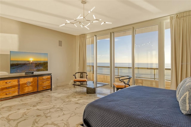 bedroom featuring access to outside, a chandelier, and a water view