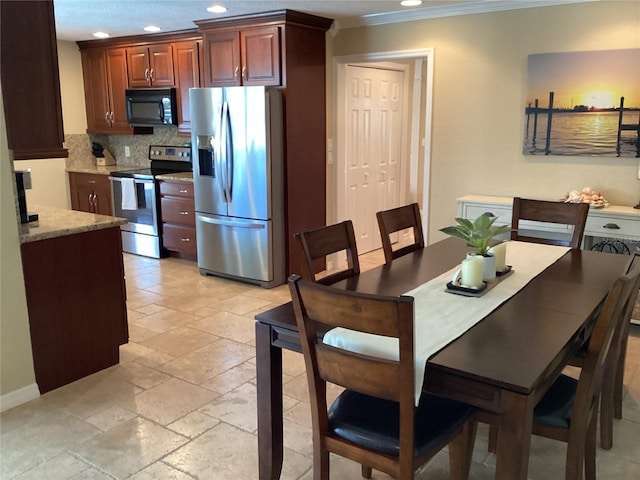 dining space with crown molding