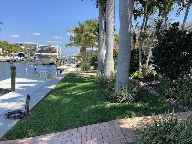 view of yard featuring a water view and a dock