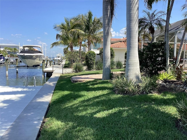 dock area featuring a yard and a water view