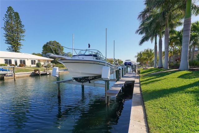 dock area featuring a water view and a yard