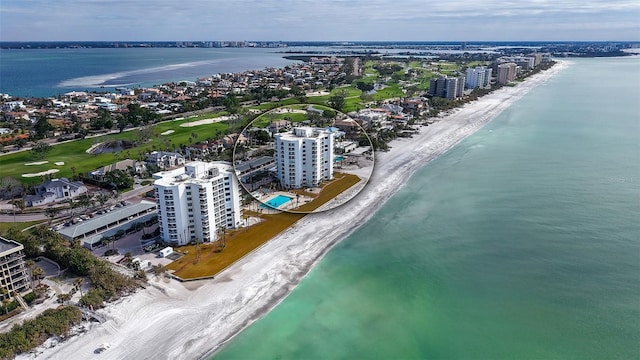 birds eye view of property featuring a water view and a beach view